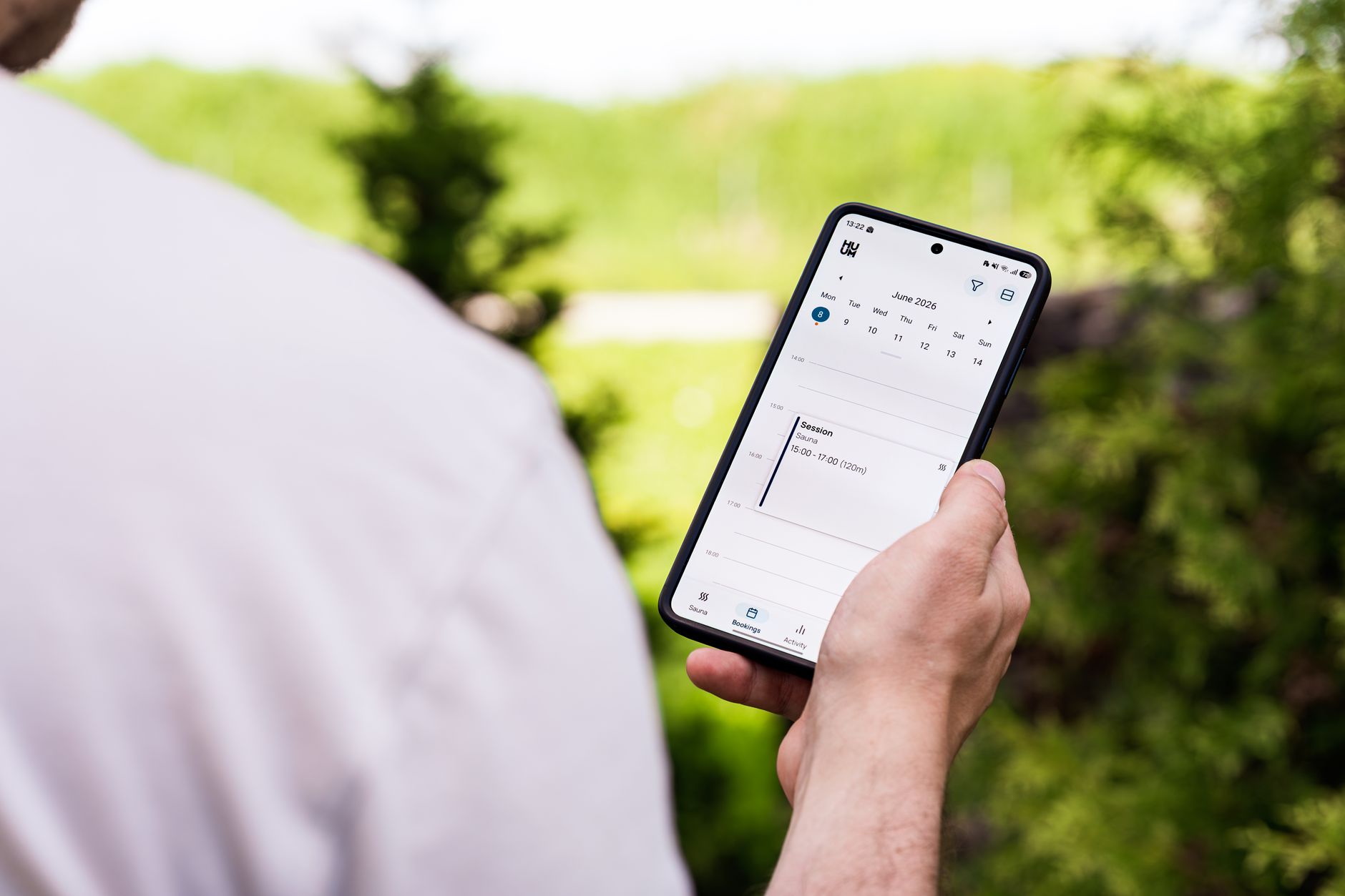 A person booking an appointment on a smartphone app outdoors